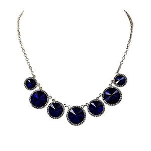 Blue crystal necklace with round blue crystals an clear crystals around them New